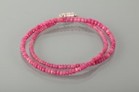 Lot 1838 - RUBY BEAD NECKLACE formed by graduated faceted...