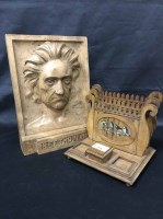 Lot 101 - AN OLIVE WOOD STATIONARY RACK AND A CARVED...