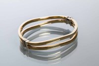 Lot 1991 - NINE CARAT GOLD BANGLE designed with two...