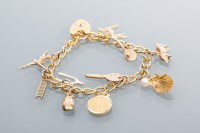 Lot 2006 - NINE CARAT GOLD CHARM BRACELET with charms...