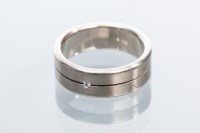 Lot 2055 - DIAMOND SET WEDDING BAND set with a single...