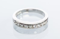 Lot 2058 - DIAMOND HALF ETERNITY RING channel set with...