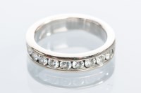 Lot 2060 - DIAMOND HALF ETERNITY RING channel set with...