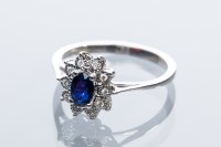Lot 2063 - SAPPHIRE AND DIAMOND CLUSTER RING with a...