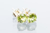 Lot 2089 - PAIR OF PERIDOT STUD EARRINGS each with a...