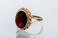 Lot 2102 - GARNET DRESS RING set with an oval garnet, in...