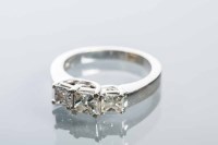 Lot 2107 - DIAMOND THREE STONE RING the central princess...