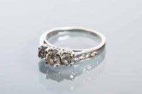 Lot 2120 - DIAMOND THREE STONE RING the central stone...