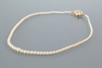 Lot 2123 - GRADUATED PEARL NECKLACE with spherical pearls,...