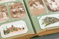 Lot 855 - TWO EXTENSIVE POSTCARD ALBUMS containing early...