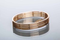 Lot 2152 - EDWARDIAN NINE CARAT GOLD BANGLE of pierced...