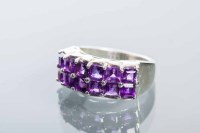 Lot 2159 - AMETHYST DRESS RING set with two rows of...