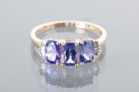 Lot 1640 - TANZANITE THREE STONE RING set with three oval...