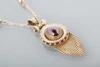 Lot 1655 - VICTORIAN GARNET AND ENAMEL PENDANT set with a...