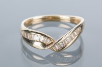 Lot 1669 - DIAMOND DRESS RING with channel set baguette...