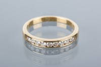 Lot 1673 - DIAMOND HALF ETERNITY RING channel set with...