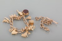 Lot 1712 - NINE CARAT GOLD CHARM BRACELET with various...