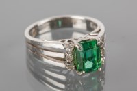 Lot 1736A - EMERALD AND DIAMOND CLUSTER RING the central...