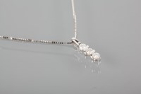 Lot 1789 - DIAMOND THREE STONE PENDANT set with three...