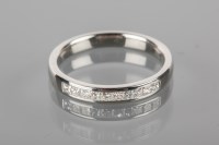 Lot 1793 - DIAMOND SET WEDDING BAND channel set with...