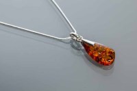Lot 2195 - BALTIC AMBER PENDANT with an irregular shaped...