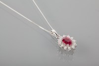 Lot 1812 - RUBY AND DIAMOND CLUSTER PENDANT ON CHAIN the...