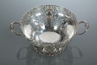 Lot 348 - GEORGE V SILVER TWIN HANDLED PIERCED FRUIT...