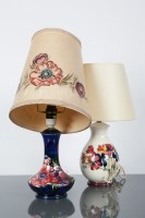 Lot 489 - TWO MOORCROFT TABLE LAMPS each decorated with...