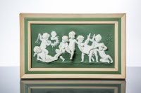 Lot 1059 - GREEN JASPERWARE PLAQUE depicting seven putti...