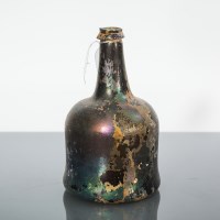 Lot 521 - 17TH CENTURY GLASS BOTTLE of bell form, 21cm high