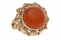 Lot 529 - NINE CARAT GOLD CORAL RING set with a large...