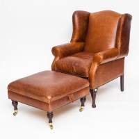 Lot 718 - TAN LEATHER WINGBACK ARMCHAIR on cabriole legs,...
