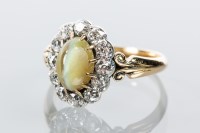 Lot 1649 - CHATOYANT GREEN GEM AND DIAMOND CLUSTER RING...