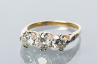 Lot 1661 - DIAMOND THREE STONE RING set with three...