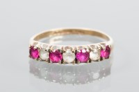 Lot 1667 - NINE CARAT GOLD RUBY RING set with alternating...