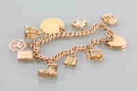 Lot 1670 - NINE CARAT GOLD CHARM BRACELET with charms...