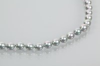 Lot 1675 - BLACK FRESHWATER PEARL NECKLACE formed by...