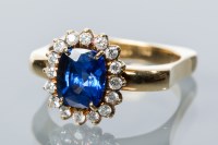 Lot 1697 - SAPPHIRE AND DIAMOND CLUSTER RING with a...