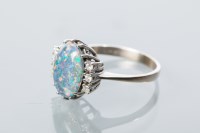 Lot 1705 - OPAL TRIPLET AND DIAMOND RING with a central...