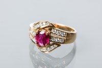 Lot 1717 - RUBY AND DIAMOND CLUSTER RING the central oval...