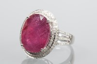 Lot 1721 - RUBY AND DIAMOND CLUSTER RING the central oval...