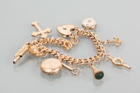 Lot 1738 - NINE CARAT GOLD CHARM BRACELET with charms...