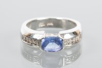 Lot 1748 - TANZANITE AND DIAMOND DRESS RING the central...