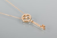 Lot 1787 - GOLD DIAMOND SET KEY PENDANT the central...