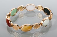 Lot 1791 - GOLD AND HARDSTONE BRACELET formed by oval...