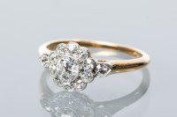 Lot 1792 - DIAMOND CLUSTER RING the bezel of floral form,...