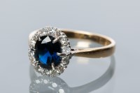 Lot 1793 - SAPPHIRE AND DIAMOND CLUSTER RING with a...