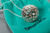 Lot 1800 - SILVER SPHERICAL PENDANT ON A CHAIN designed...