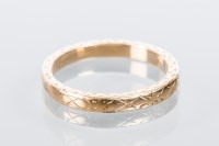 Lot 1808 - EIGHTEEN CARAT GOLD WEDDING BAND with engraved...