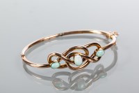 Lot 1809 - EARLY TWENTIETH CENTURY OPAL BANGLE of knot...